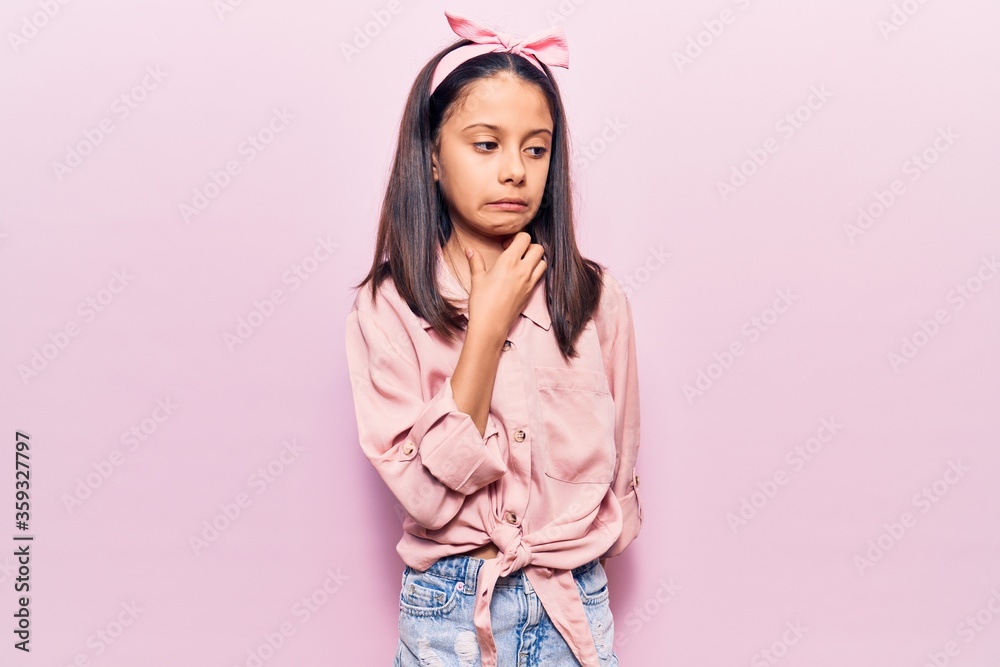 Beautiful child girl wearing casual clothes touching painful neck, sore throat for flu, clod and infection