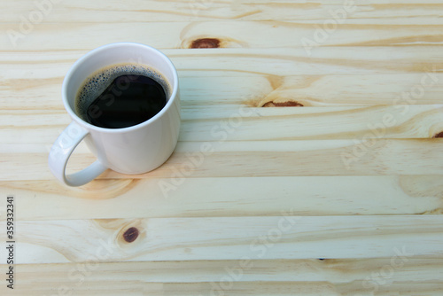 Coffee of the day, americano coffee cup free space on wooden background , top view.