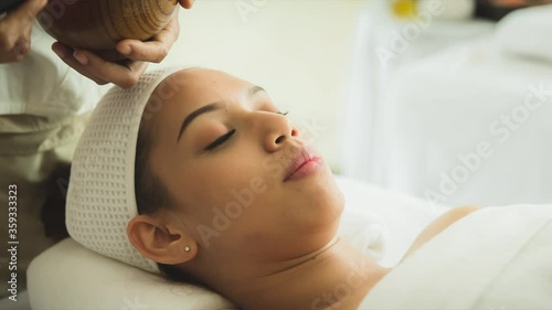closed up young woman taking face masking treatment, by using natural black charcoal.