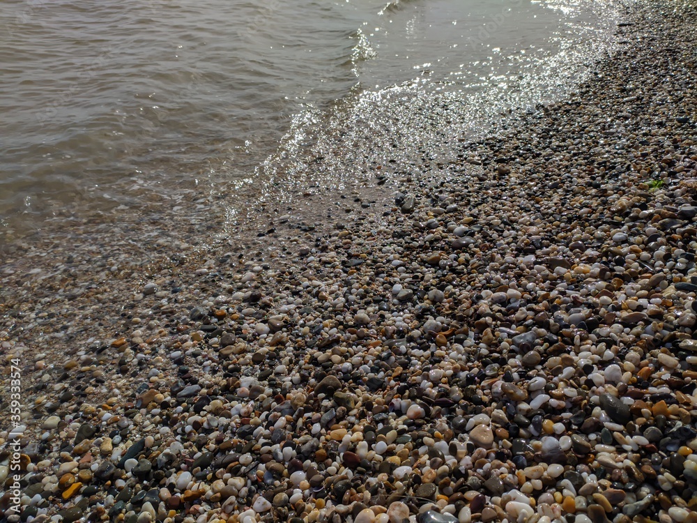 Shore of the Black Sea. In the foreground are photographs of a pebble beach and sea stretching over the horizon. Waves at sea. Shore of the Black Sea. In the foreground are photographs of a pebble beach and sea stretching over the horizon. Waves at sea.
