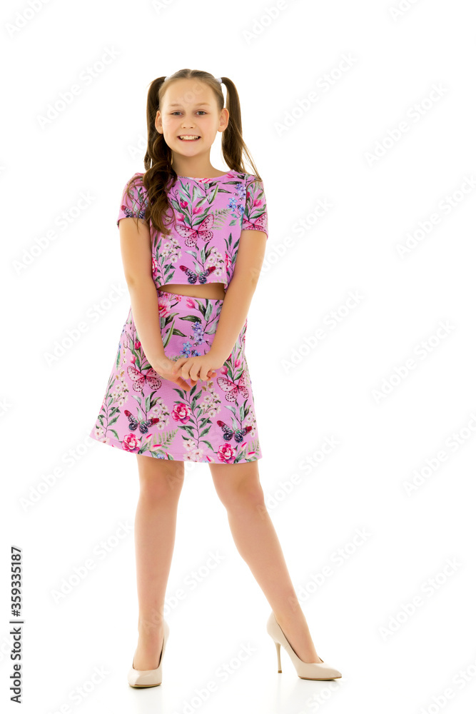 Cheerful little girl in large shoes taken from her mother. Cheerful little girl in large shoes taken from her mother.