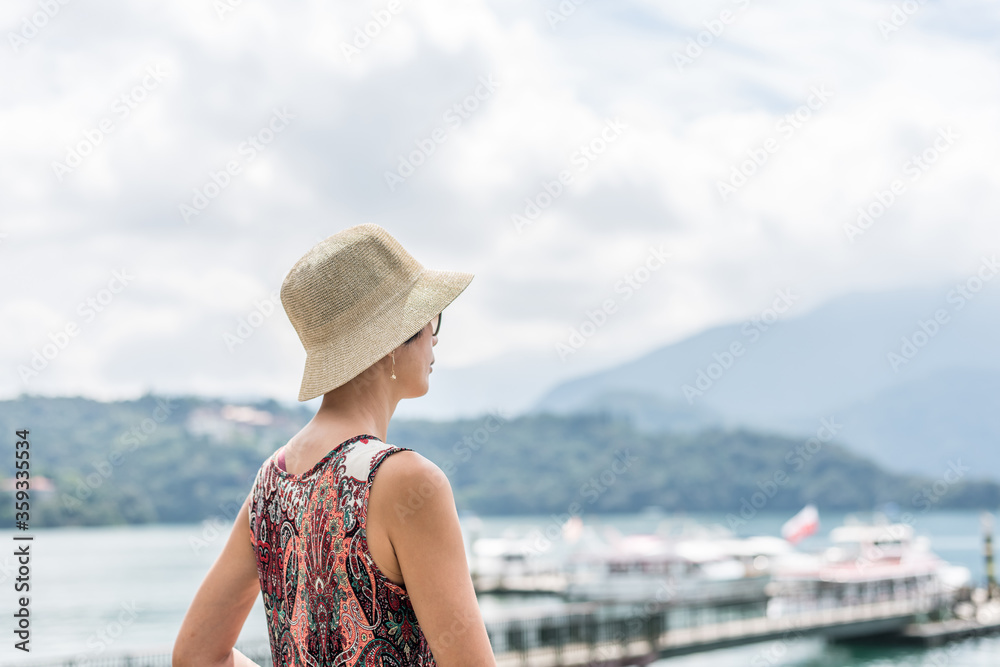 traveling Asian woman with hat