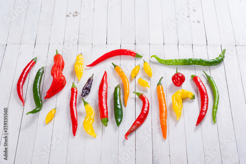 chili pepper selection on white wood table background photo