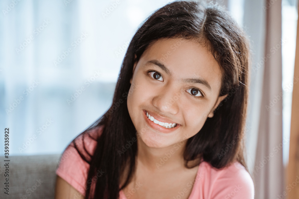 asian happy young teenage girl smiling to camera