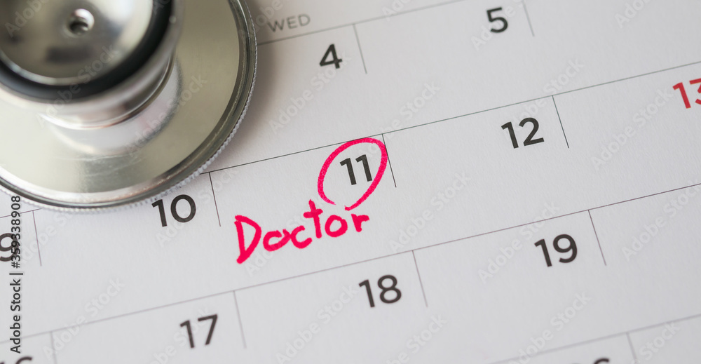 Stethoscope with calendar page date background doctor appointment medical concept Stethoscope with calendar page date background doctor appointment medical concept