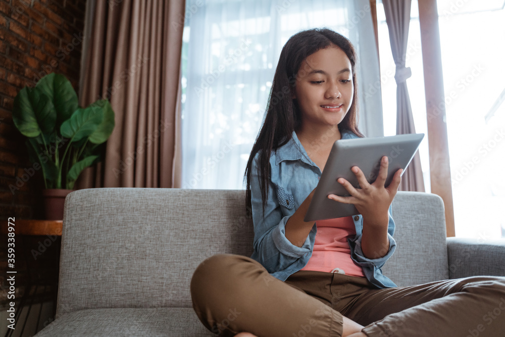 smile young teen using tablet pc while staying home smile young teen using tablet pc while staying home