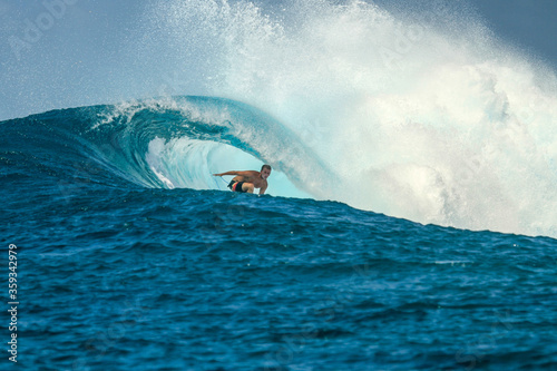 Surfer on perfect blue wave, in the barrel, clean water, Indian Ocean © Lila Koan