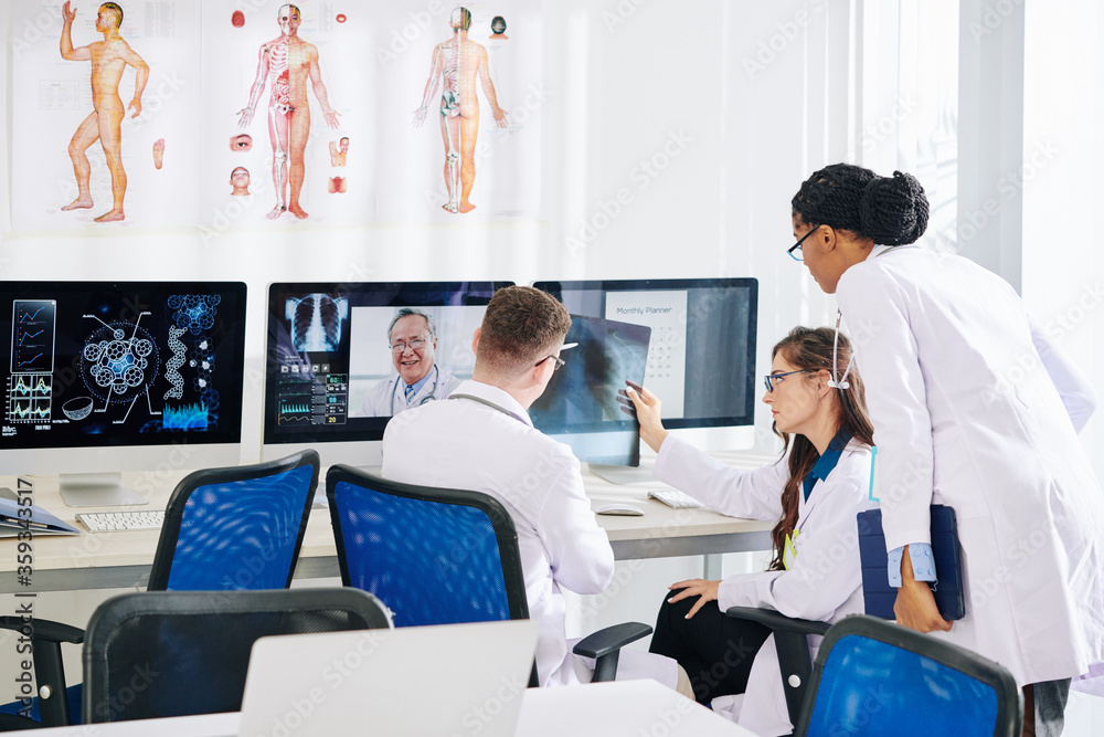 Obraz premium Group of medical researchers discussing lungs x-ray of patient with experienced pulmonologist