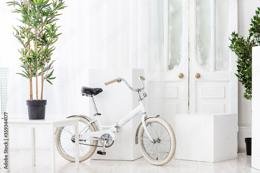 White bicycle room and a door White bicycle room and a door