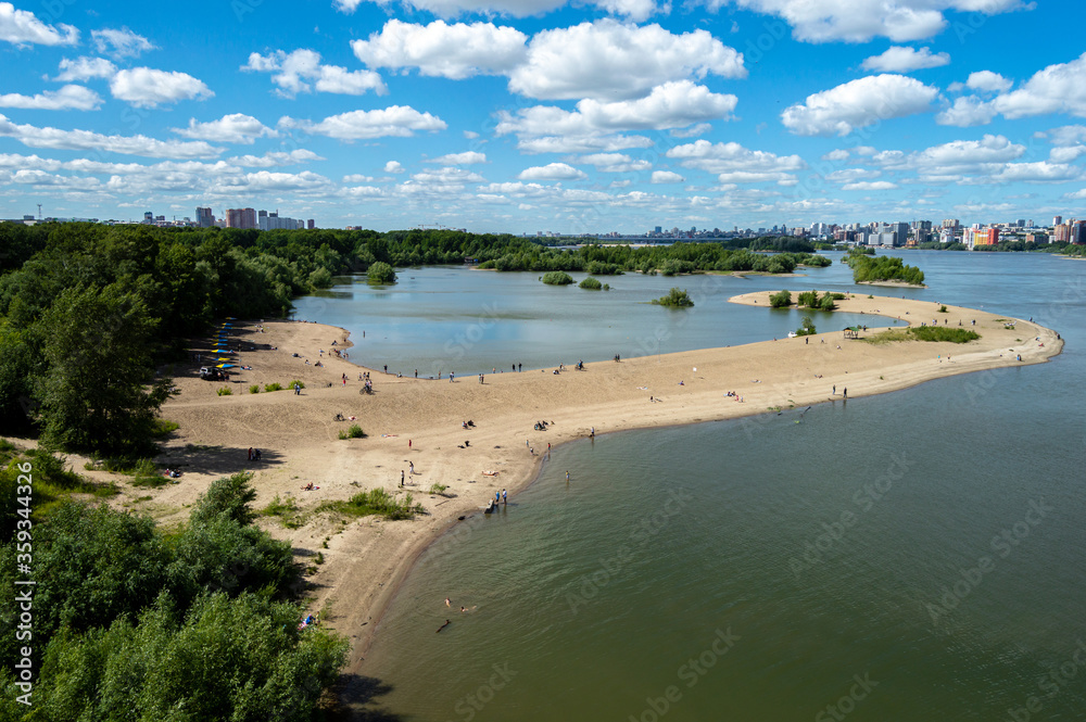 A beach with people swimming, photographed from afar A beach with people swimming, photographed from afar