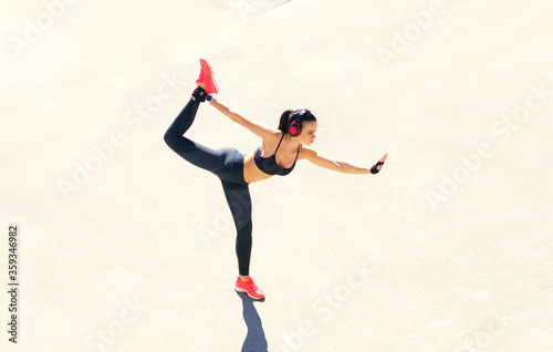 Young, fit and sporty woman doing exercises outdoor. Fitness, sport and healthy lifestyle.