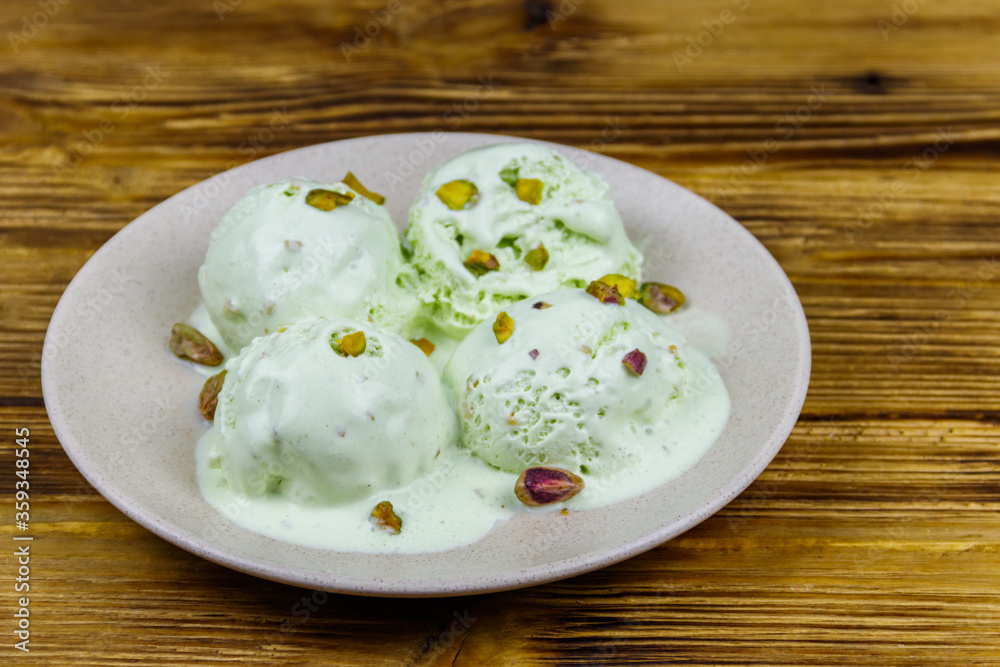 Pistachio ice cream on wooden table Pistachio ice cream on wooden table