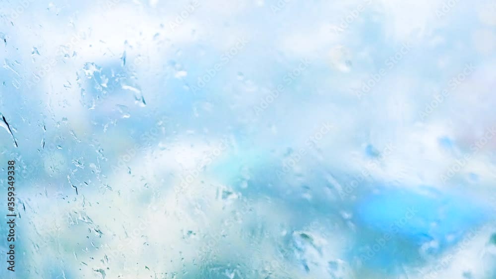 Rain drops on glass window in the city, rain season Rain drops on glass window in the city, rain season