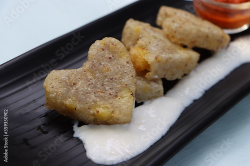 Sabudana vada or wada, sabu vada, traditional deep fried snack made with tapioca balls from Maharashtra, India, served with curd  photo