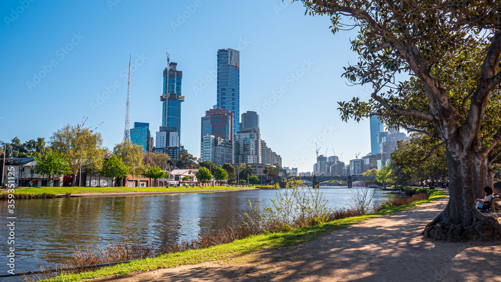 Melbourne City in a bright nice day of spring. Yarra River, bridge, residential and commercial buildings. Trade marks removed, non recognisable people.