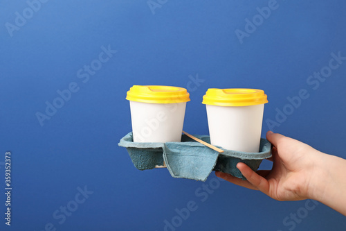 Hand holding two white disp...