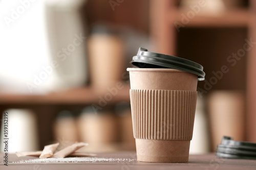 Takeaway coffee cup on table in cafe photo