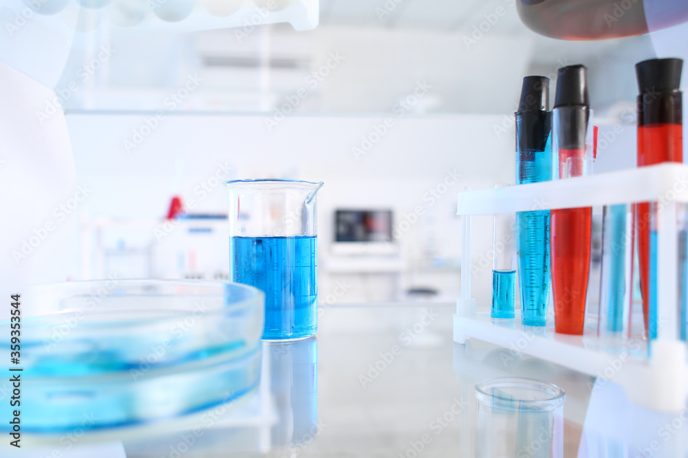 Glassware with samples on shelf in laboratory Glassware with samples on shelf in laboratory