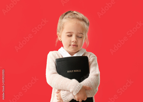 Little girl with Bible on c...