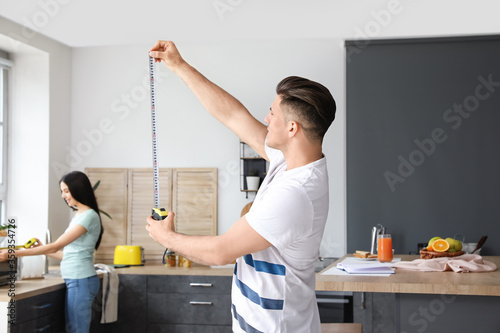 Young man with measuring ta...