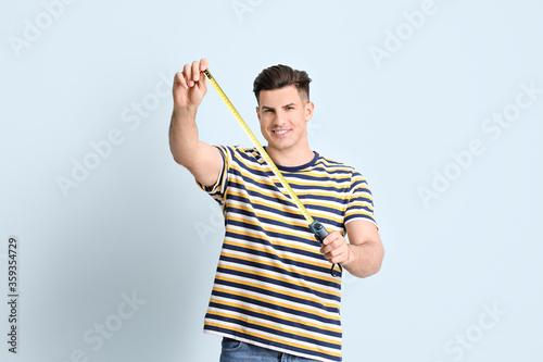 Young man with measuring ta...