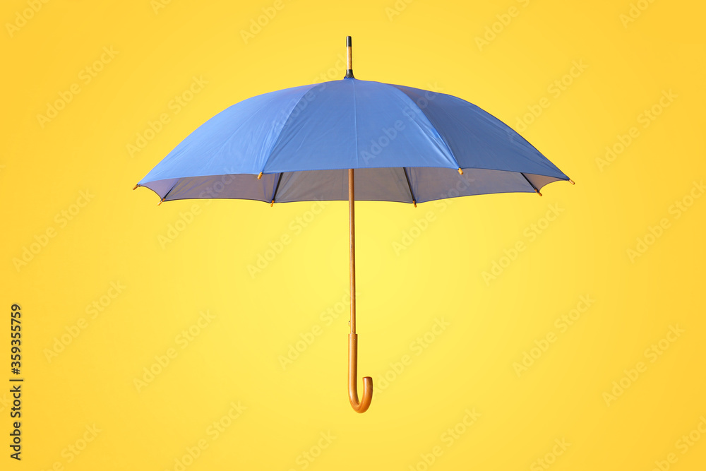 Stylish umbrella on color background