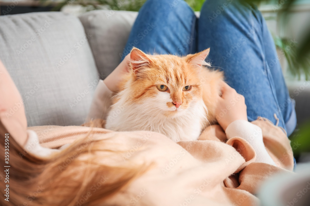 Woman with cute cat at home