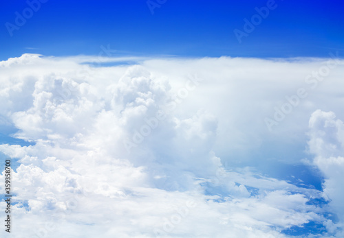 Fototapeta Naklejka Na Ścianę i Meble -  White cumulus clouds on clear blue sky background, aerial cloudscape panoramic view from airplane, high azure skies panorama, fluffy cloud backdrop, sunny heaven, cloudy flight landscape, copy space