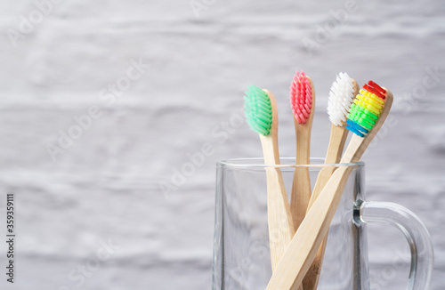 A toothbrush in a cup set against a marble background.