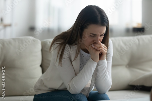 Cheated young woman wife goes through divorce sitting on couch thinking, blames herself for marriage family split feels hopeless. Unplanned pregnancy and abortion, infertility health problems concept