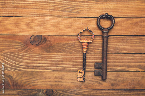 Old keys on wooden background