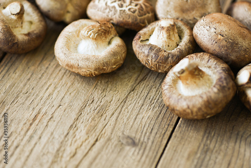 Fresh mushrooms on wooden table background - Shiitake mushrooms