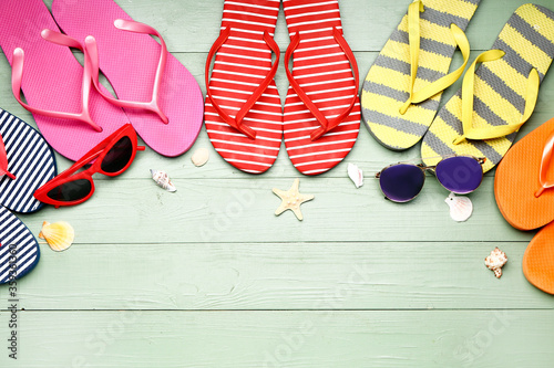 Summer composition with flip-flops on wooden background