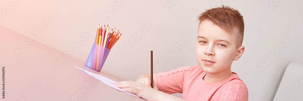 Little boy drawing. Closed Locking Exercise. Homemade routine. School lessons. Write pencil on piece of paper. Kindergarten study. Elementary preschool. Man kid students. Horizontal banner
