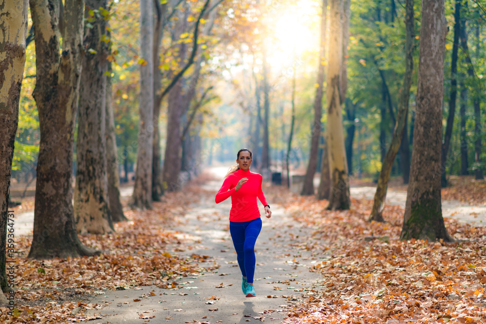 Fototapeta premium Woman Jogging Outdoors in Park