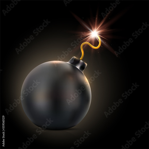 Round black bomb with lit fuse on dark background