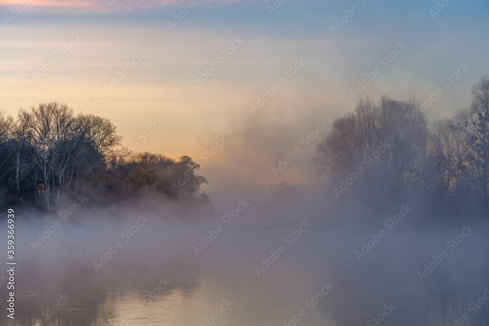 Fall landscape with river on sunrise and over water