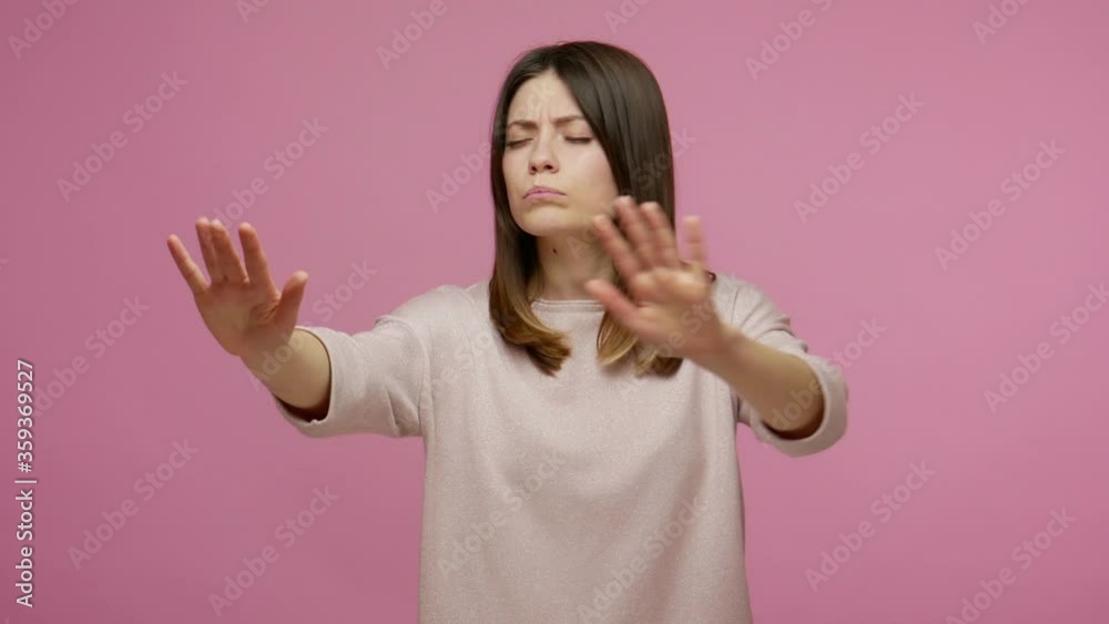 I can't see! Lonely brunette young woman touching air, searching obstacles while walking with closed eye, having vision problems, lost road in darkness. indoor studio shot isolated on pink background I can't see! Lonely brunette young woman touching air, searching obstacles while walking with closed eye, having vision problems, lost road in darkness. indoor studio shot isolated on pink background