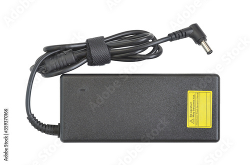 Power adapter. AC to DC converter for laptop. Black plastic rectangular box with cable and L-shaped connector 5.5 by 2.5 mm. Top view. Isolated on white. photo