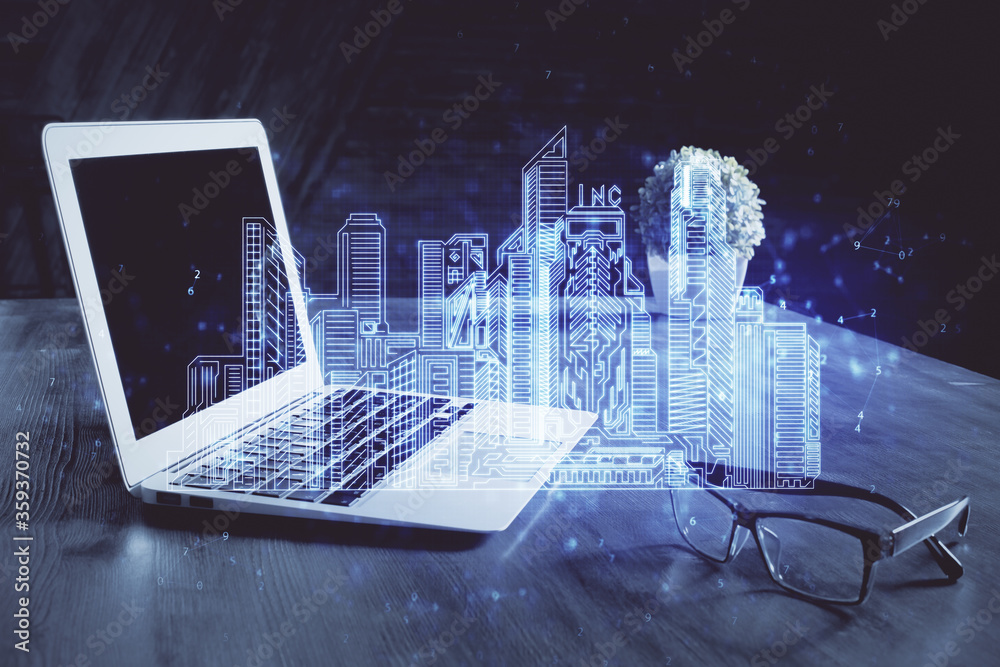 Desktop computer background in office and big town buildings hologram drawing. Double exposure. Smart city concept. Desktop computer background in office and big town buildings hologram drawing. Double exposure. Smart city concept.