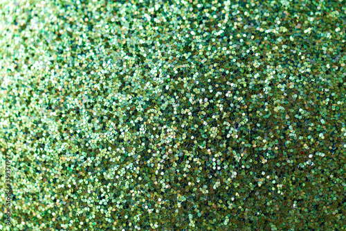 party, texture and holidays concept - green glitters or sequins background