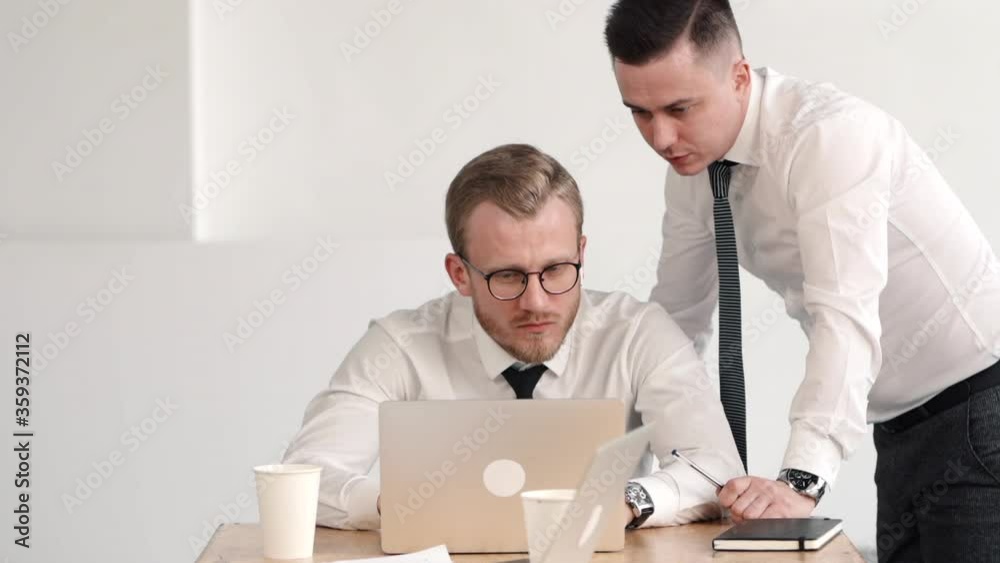 man looking at coworker laptop screen and giving advice help consultation about work. person typing document report business project idea. concept finance, cooperation, talking man looking at coworker laptop screen and giving advice help consultation about work. person typing document report business project idea. concept finance, cooperation, talking