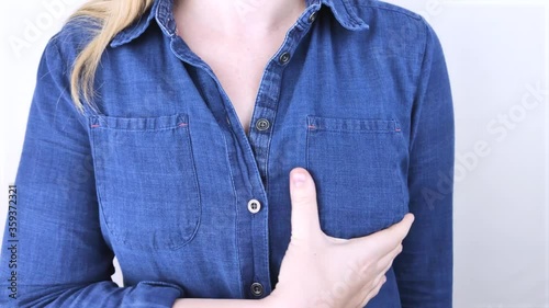 A woman suffers from chest pain. On examination by a gynecologist-mammologist. The concept of the prevention of breast diseases, cancer, mastopathy or hormonal disorders photo