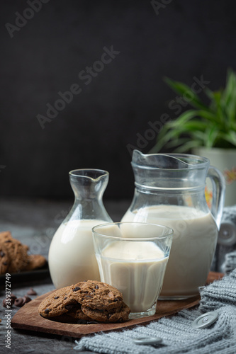 milk products tasty healthy dairy products on a table on sour cream in a bowl, cottage cheese bowl, cream in a a bank and milk jar, glass bottle and in a glass.