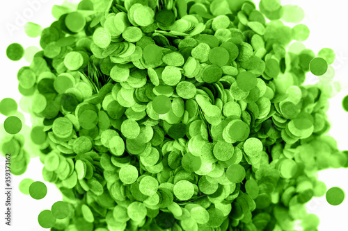 Festive green confetti background. Flat lay style.