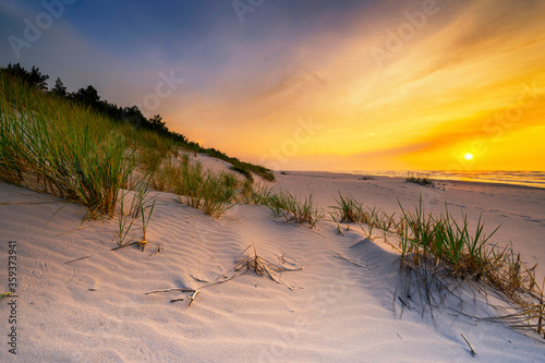 Fototapeta Naklejka Na Ścianę i Meble -  Beautiful summer sunset over beach at Baltic sea