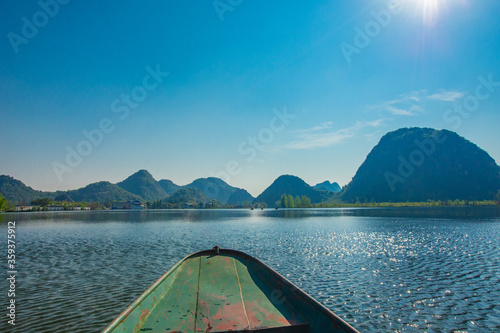 Boat view of Puzhehei, a typical Karst landscape in Yunnan, China. © Zimu