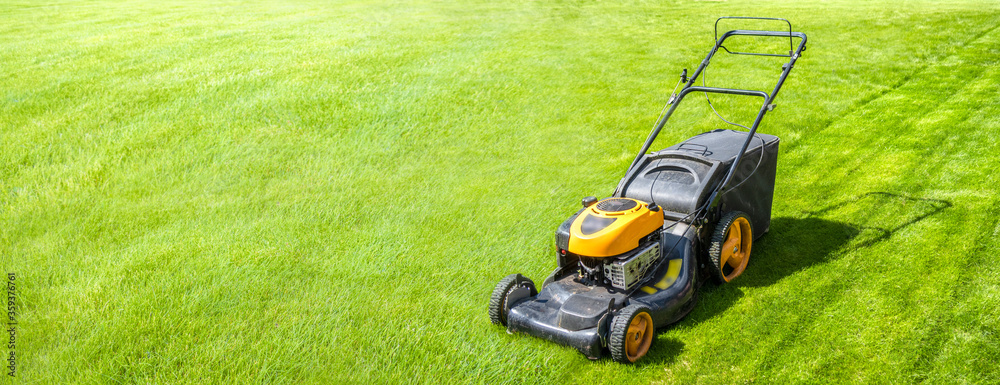Εκτύπωση καμβά Lawn mower on fresh green lawn, freshly cut grass on summer sunny day, banner