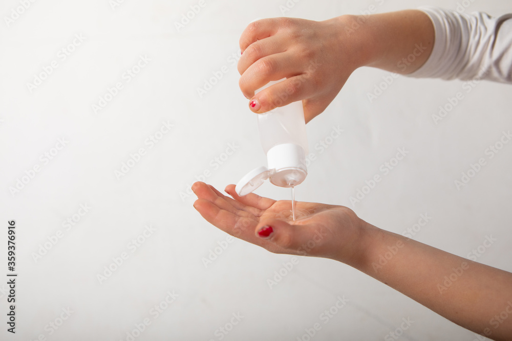 hands of a female child desinfecting hands with nail polish with a bottle. hands of a female child desinfecting hands with nail polish with a bottle.