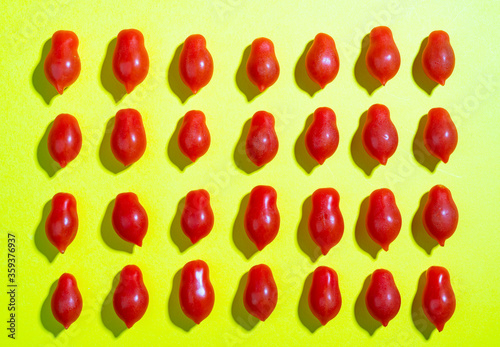 Datterino tomatoes on a yellow surface